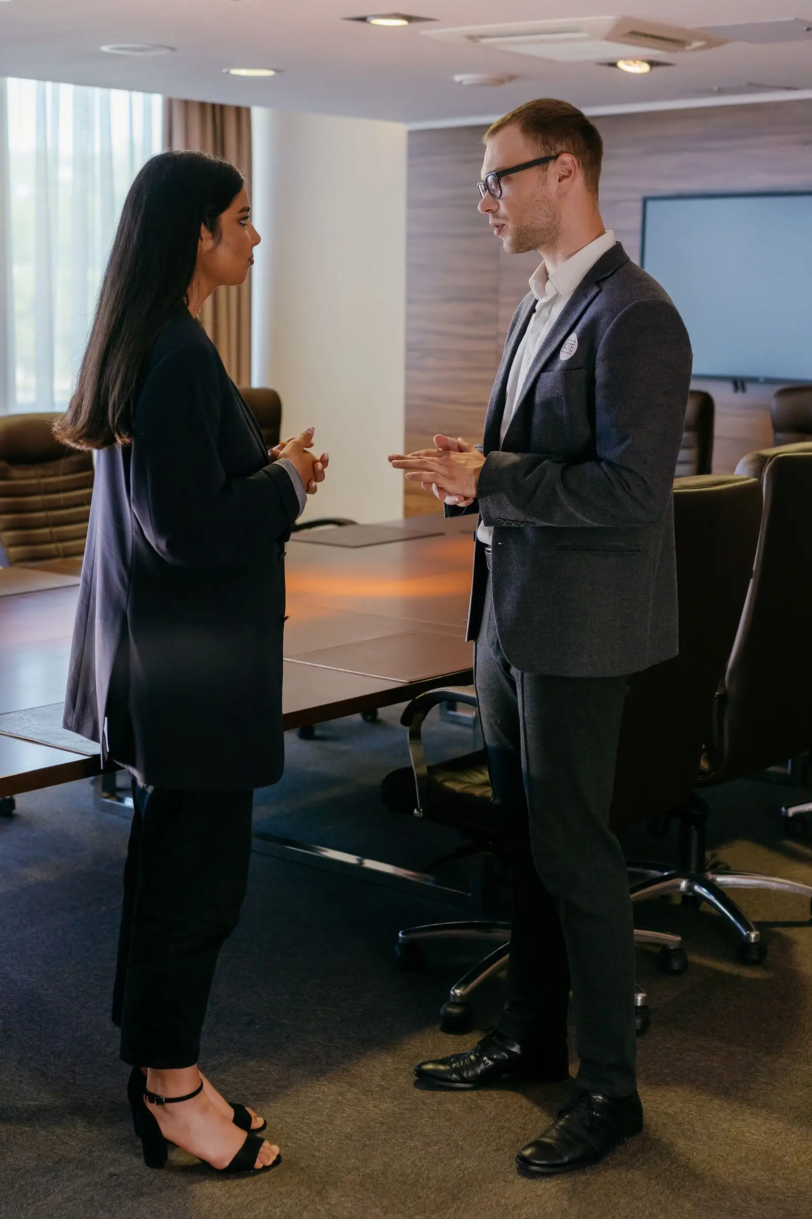 Two leaders talking in a boardroom